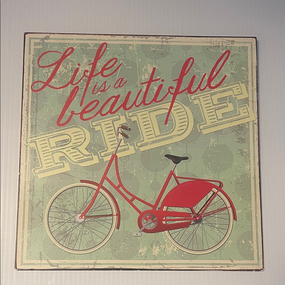 Metal square sign featuring a red bicycle